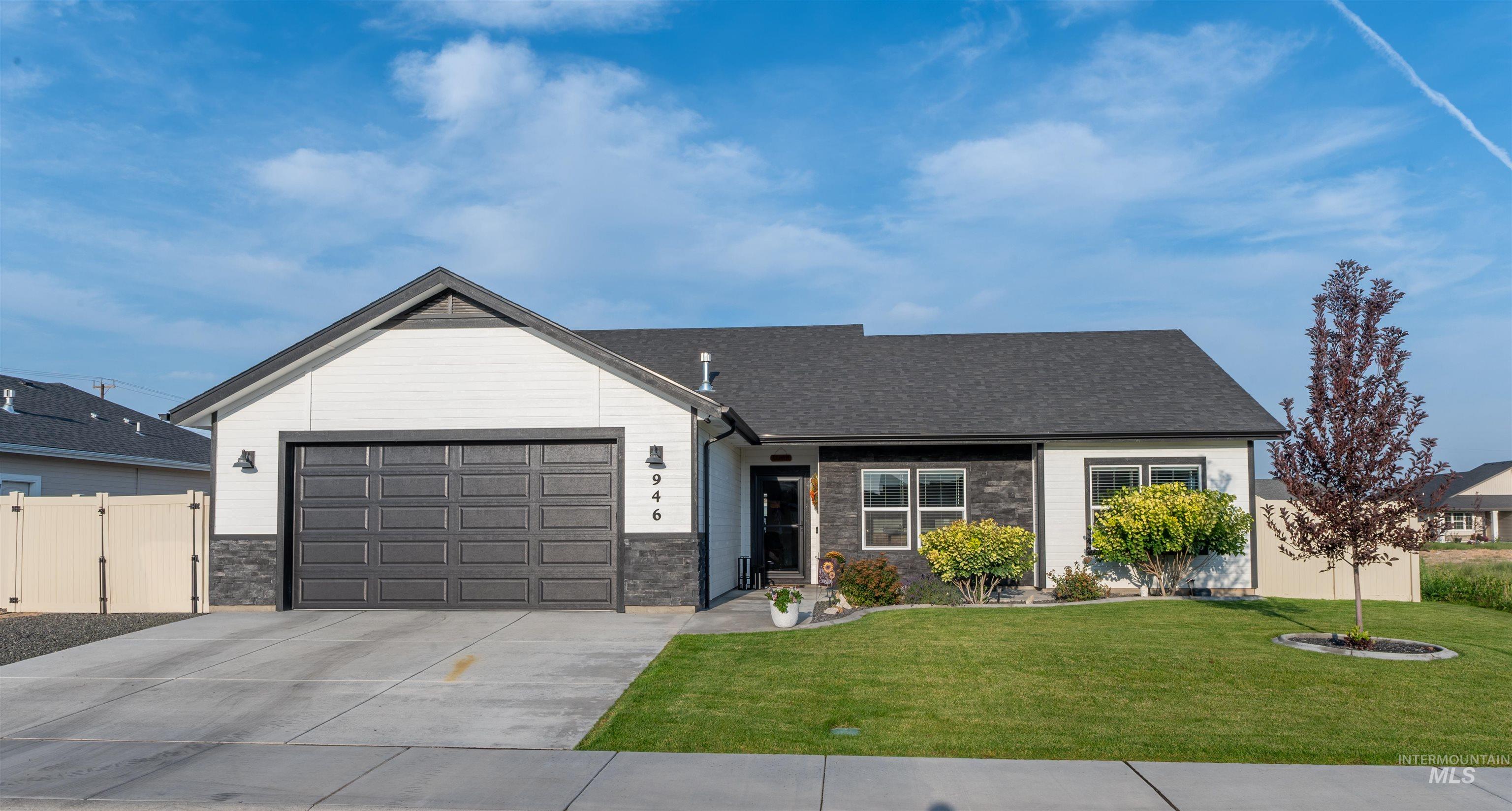946 Kenbrook Loop Twin Falls, ID 83301 - Photo 24 of 35 View of front of property with stone siding, driveway, an attached garage, and a shingled roof