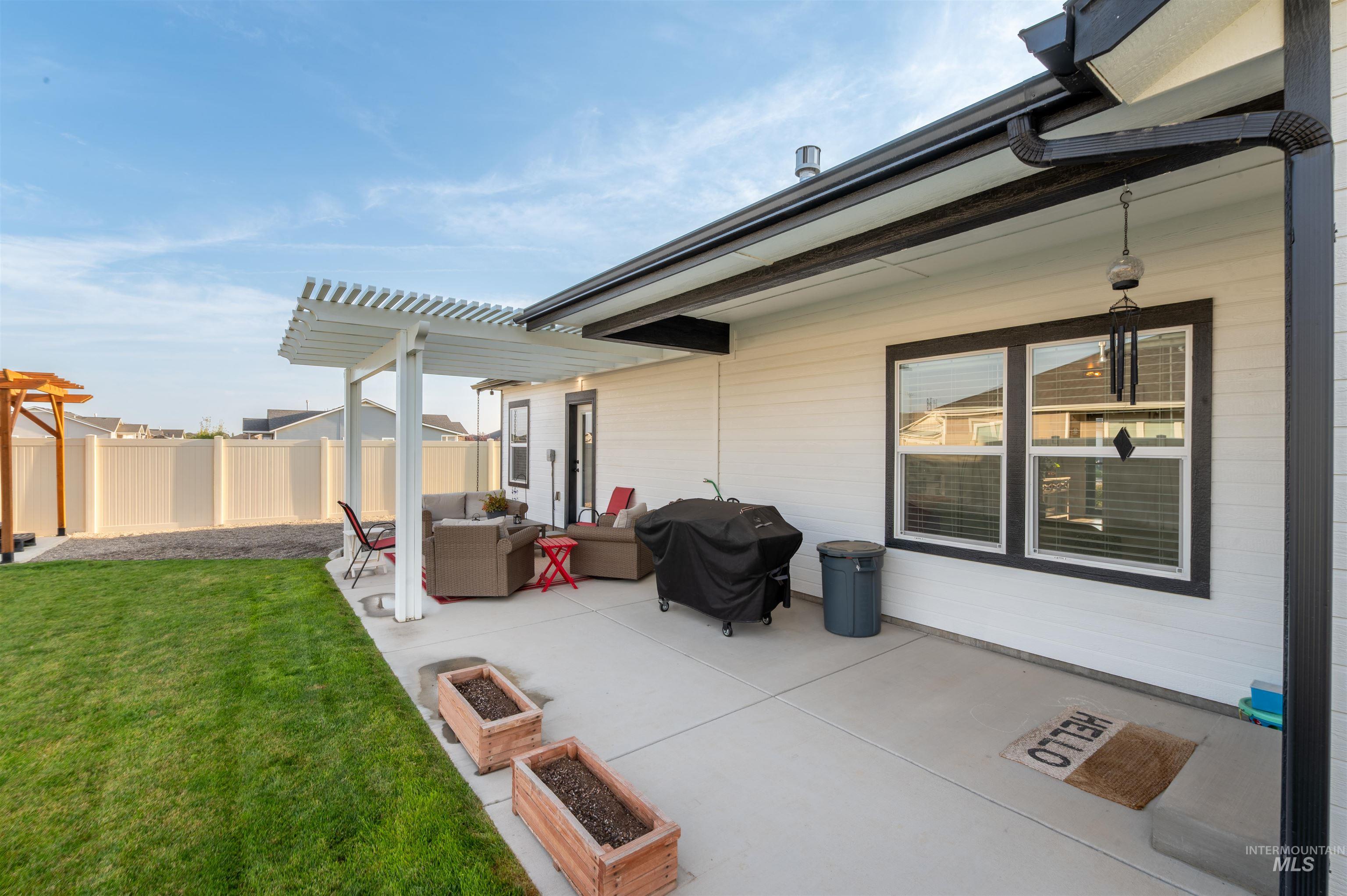 946 Kenbrook Loop Twin Falls, ID 83301 - Photo 25 of 35 View of patio with a grill, an outdoor living space, a garden, and a pergola
