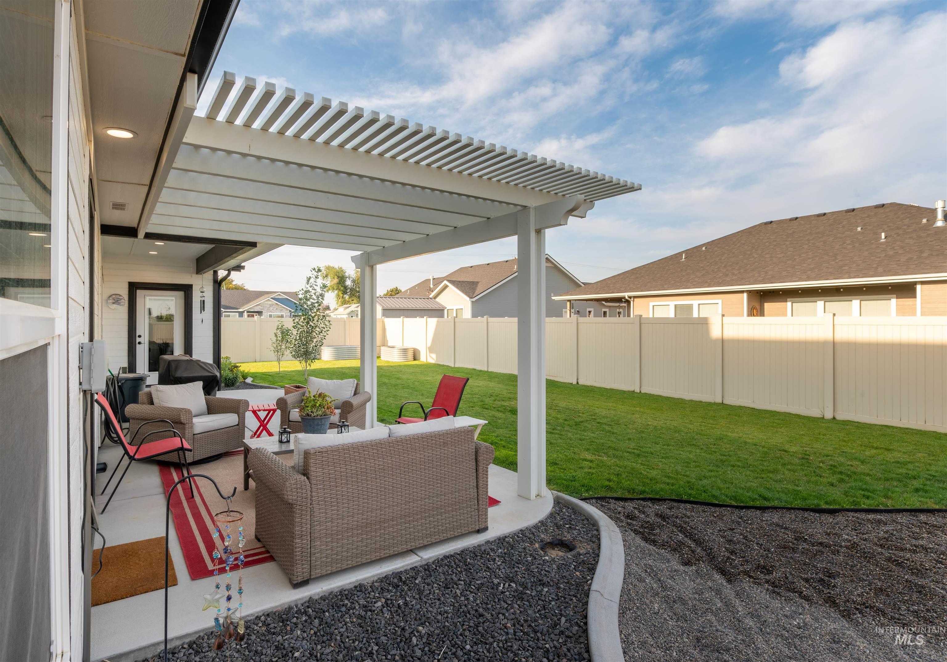 946 Kenbrook Loop Twin Falls, ID 83301 - Photo 28 of 35 Fenced backyard with a pergola, a patio area, and outdoor lounge area