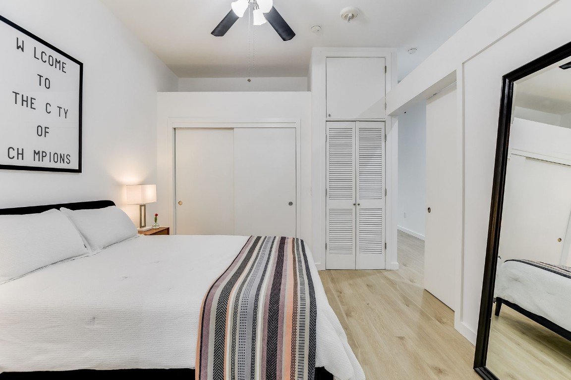 507 Sabine Street, Unit 303 Austin, TX 78701 - Photo 11 of 28 a bedroom with a bed and a walk in closet