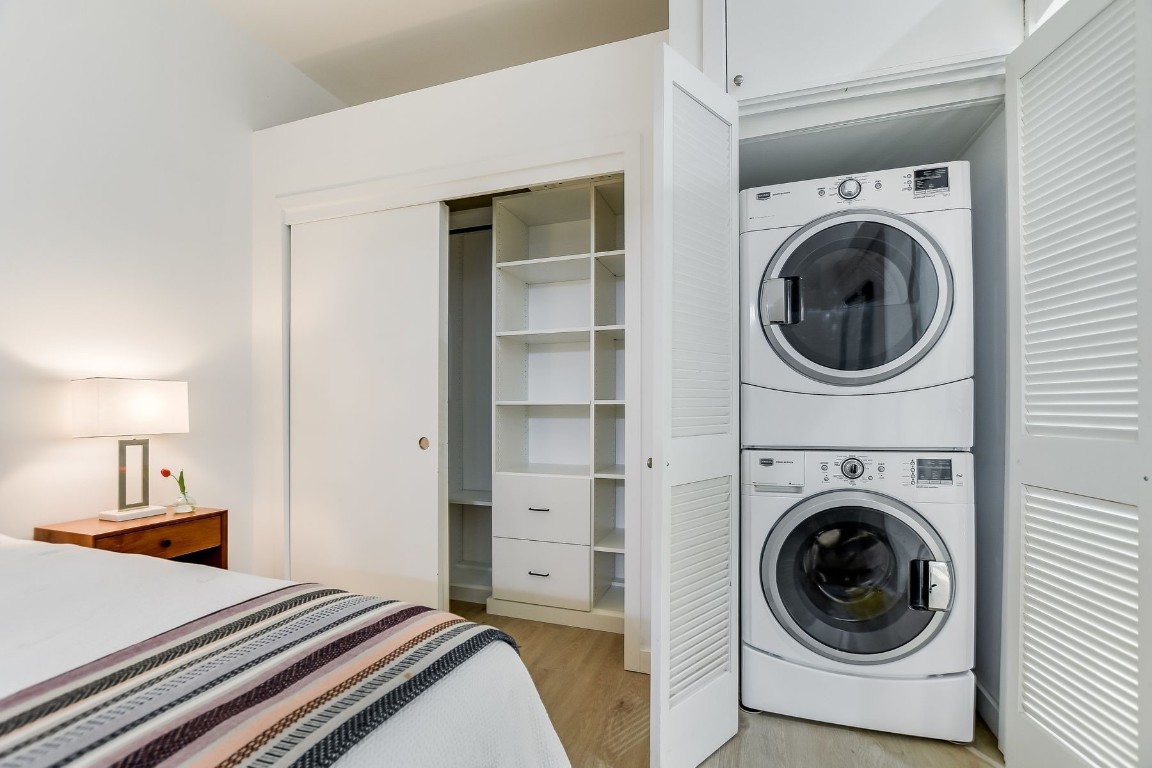507 Sabine Street, Unit 303 Austin, TX 78701 - Photo 12 of 28 a view of a bedroom with washer and dryer