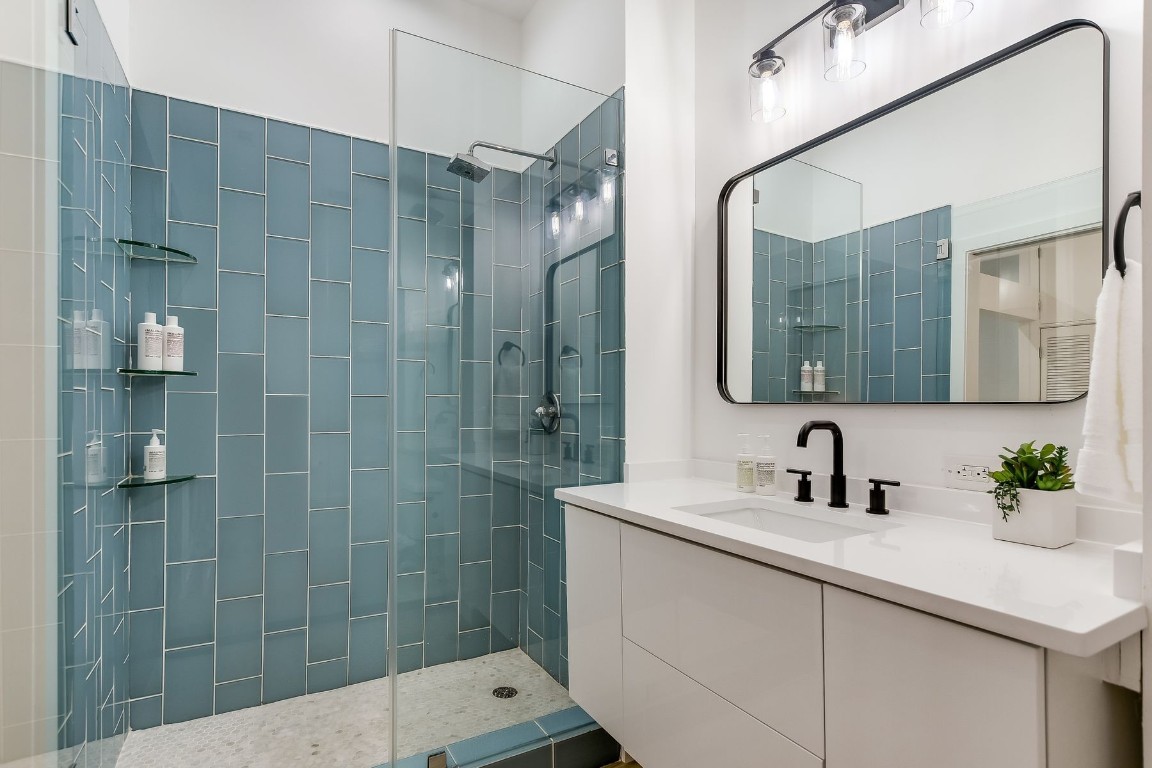 507 Sabine Street, Unit 303 Austin, TX 78701 - Photo 15 of 28 a bathroom with a sink shower and a mirror