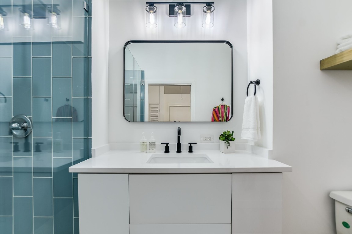 507 Sabine Street, Unit 303 Austin, TX 78701 - Photo 16 of 28 a bathroom with a sink and a mirror