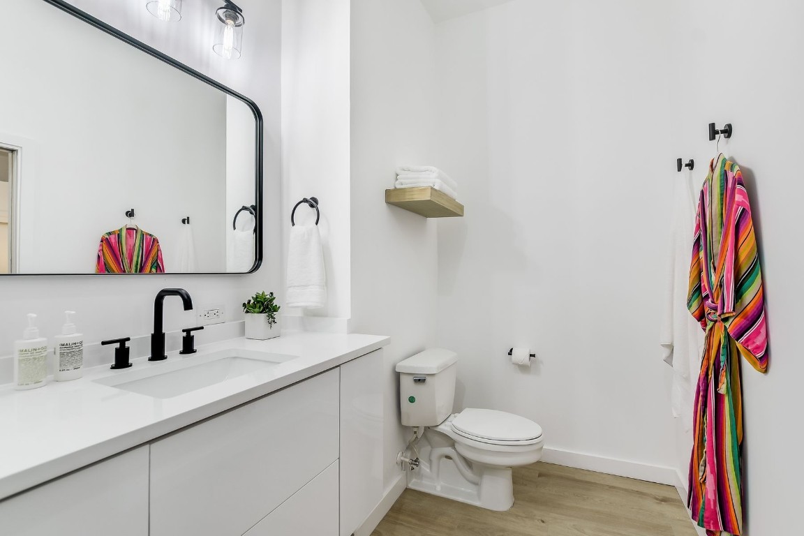 507 Sabine Street, Unit 303 Austin, TX 78701 - Photo 17 of 28 a bathroom with a sink vanity mirror and toilet