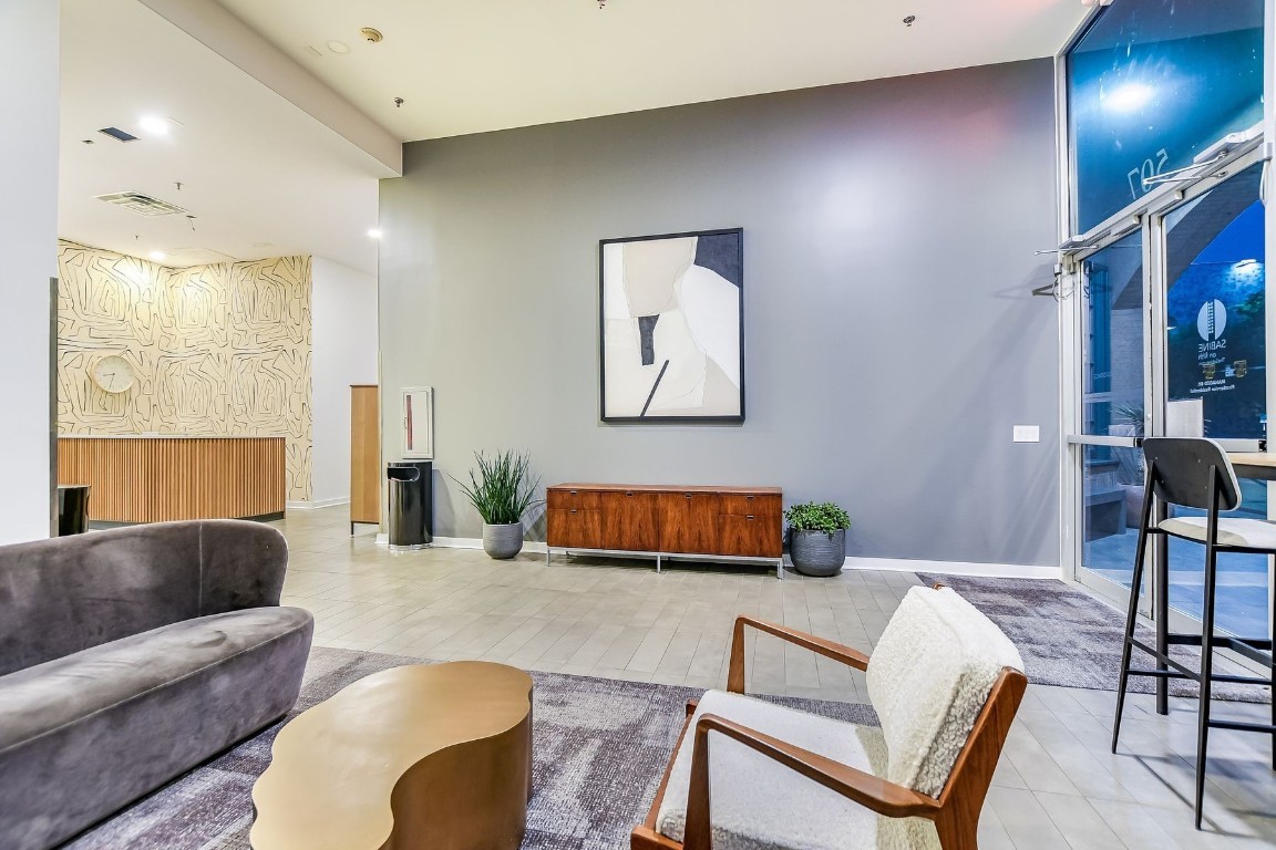 507 Sabine Street, Unit 303 Austin, TX 78701 - Photo 20 of 28 a living room with furniture and a lamp