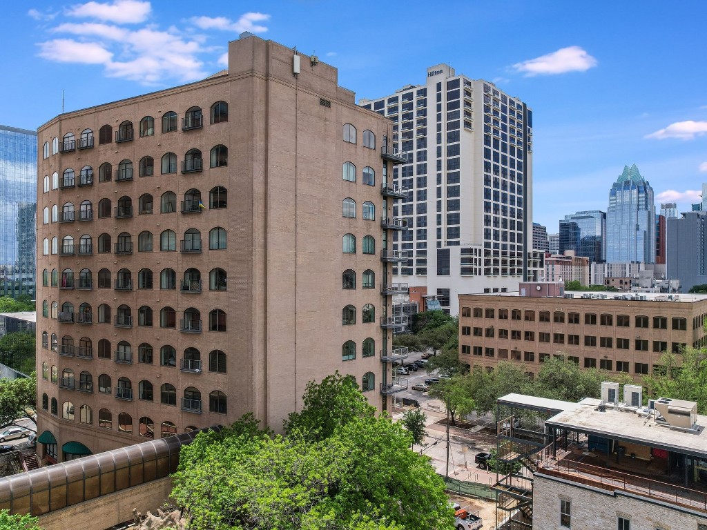 507 Sabine Street, Unit 303 Austin, TX 78701 - Photo 22 of 28 a view of a building with a yard