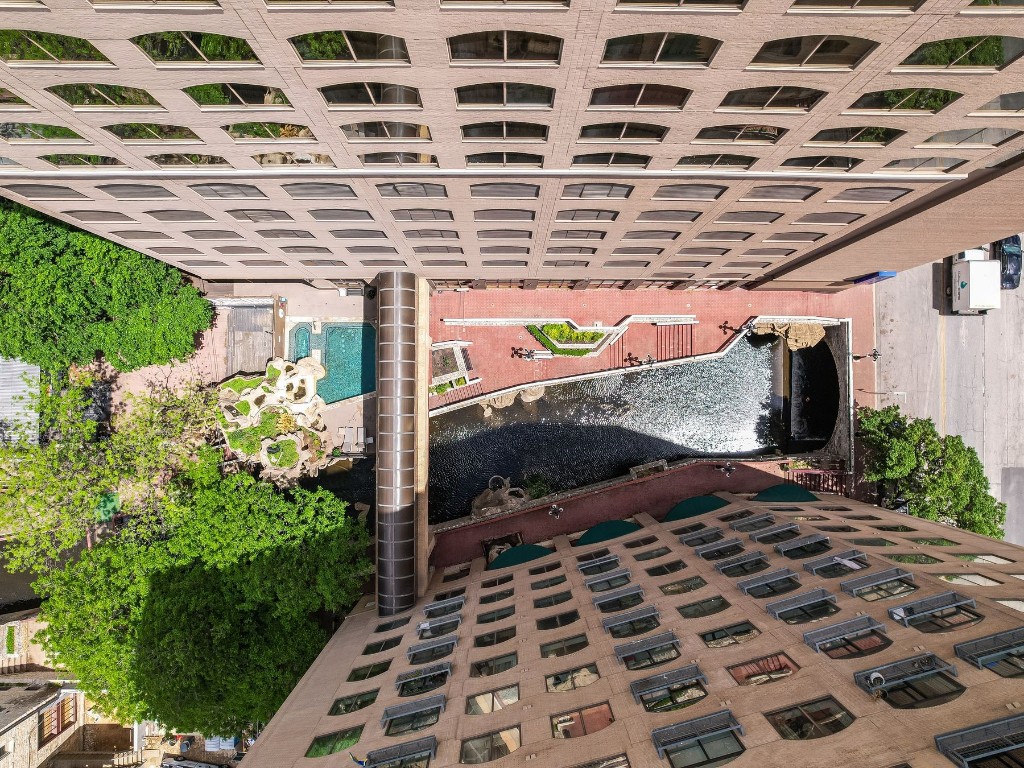 507 Sabine Street, Unit 303 Austin, TX 78701 - Photo 26 of 28 a view of a patio with table and chairs