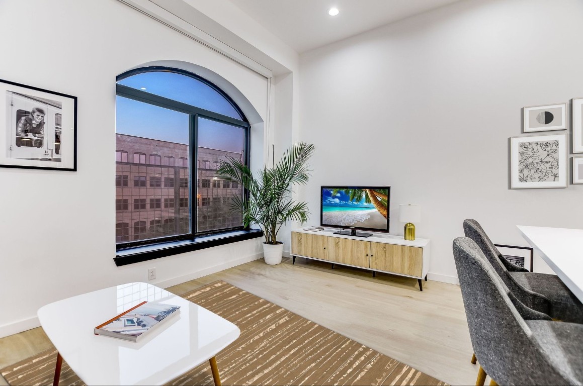507 Sabine Street, Unit 303 Austin, TX 78701 - Photo 3 of 28 a living room with furniture and a flat screen tv