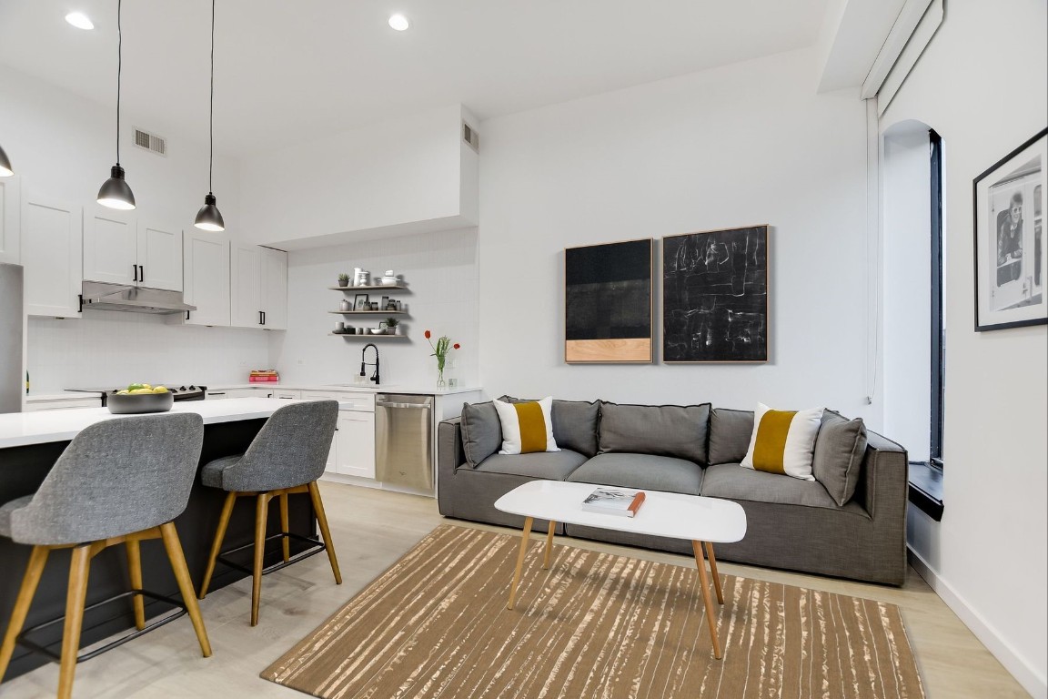 507 Sabine Street, Unit 303 Austin, TX 78701 - Photo 4 of 28 a living room with furniture and a wooden floor