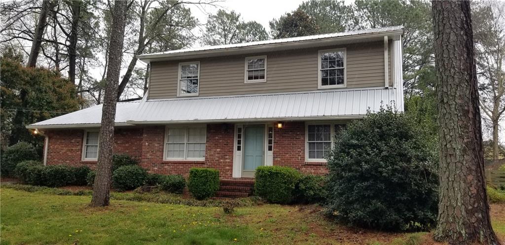 2548 3 Bars Drive Grayson, GA 30017 - Photo 1 of 1 a front view of a house with garden