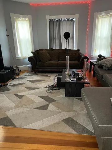 a living room with furniture and a mirror