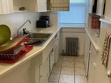 a kitchen with a sink a stove and cabinets