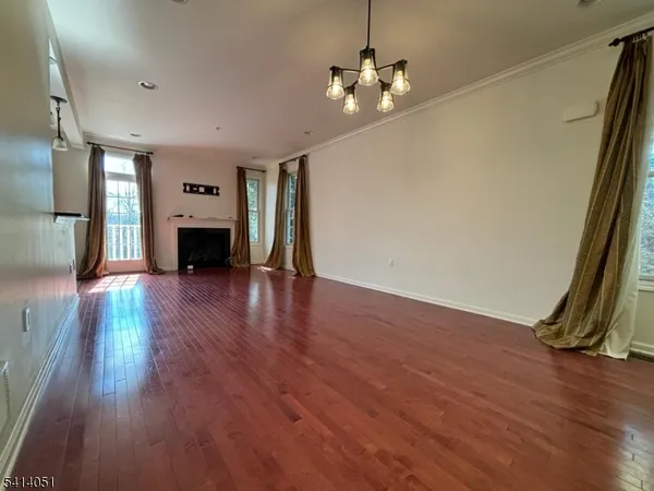 a view of an empty room with window and fireplace