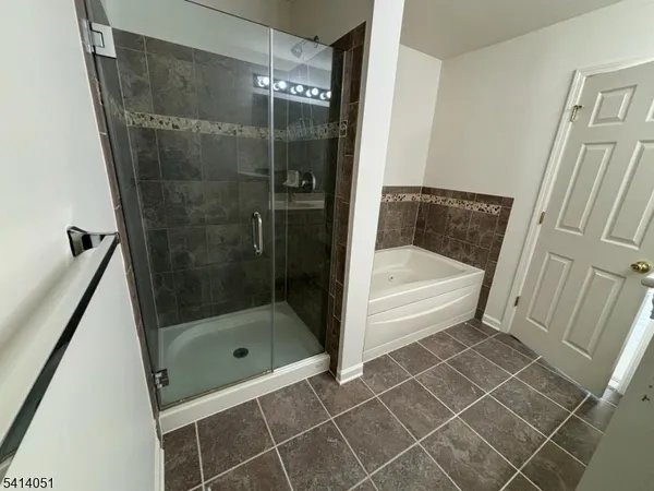 a bathroom with a glass door shower and a sink