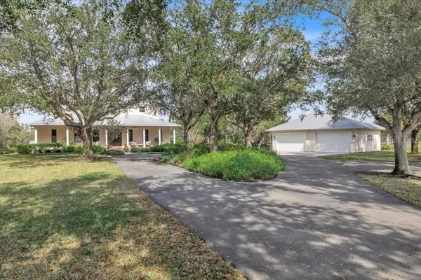 a front view of a house with a yard and a garage