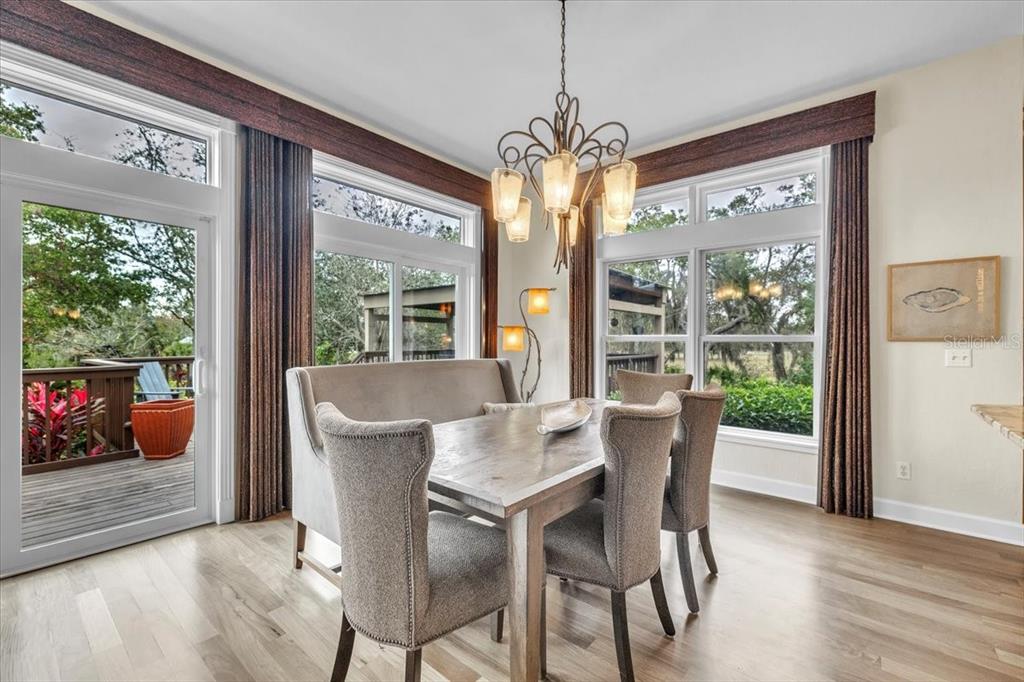 3850 Acline Road Punta Gorda, FL 33950 - Photo 13 of 50 a view of a dining room with furniture wooden floor and chandelier