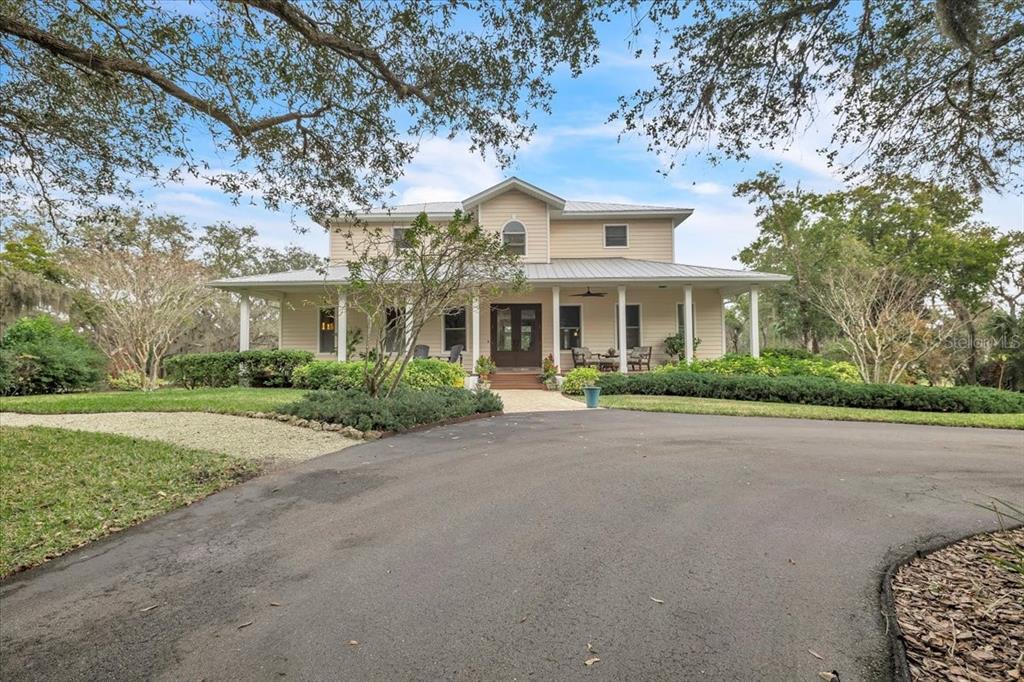 3850 Acline Road Punta Gorda, FL 33950 - Photo 2 of 50 a front view of a house with a garden