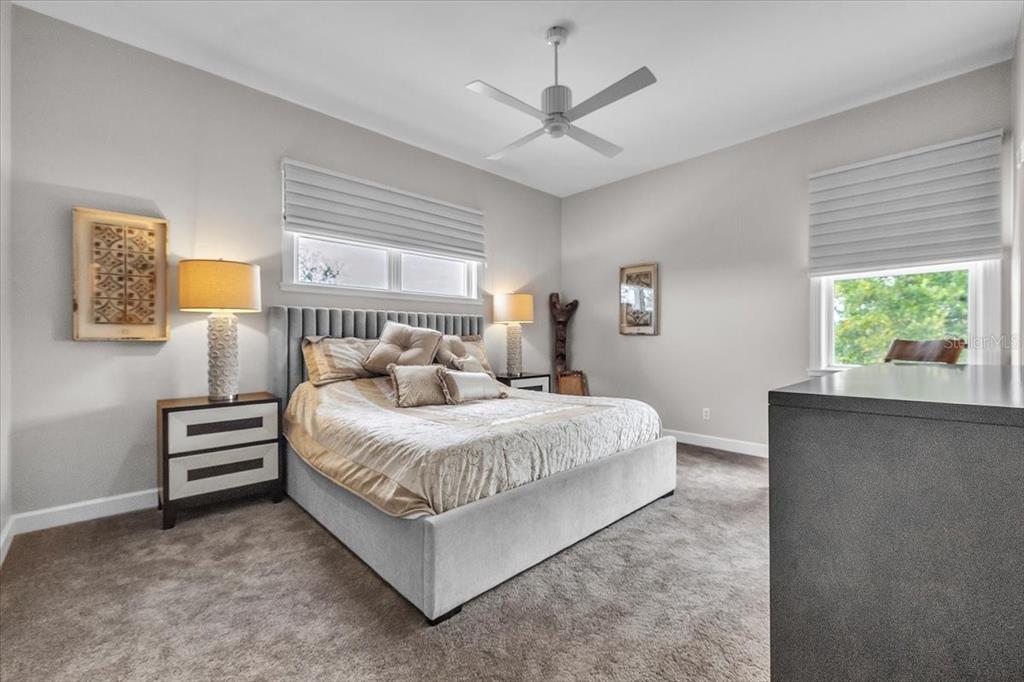 3850 Acline Road Punta Gorda, FL 33950 - Photo 30 of 50 a bedroom with a bed a window and a chandelier