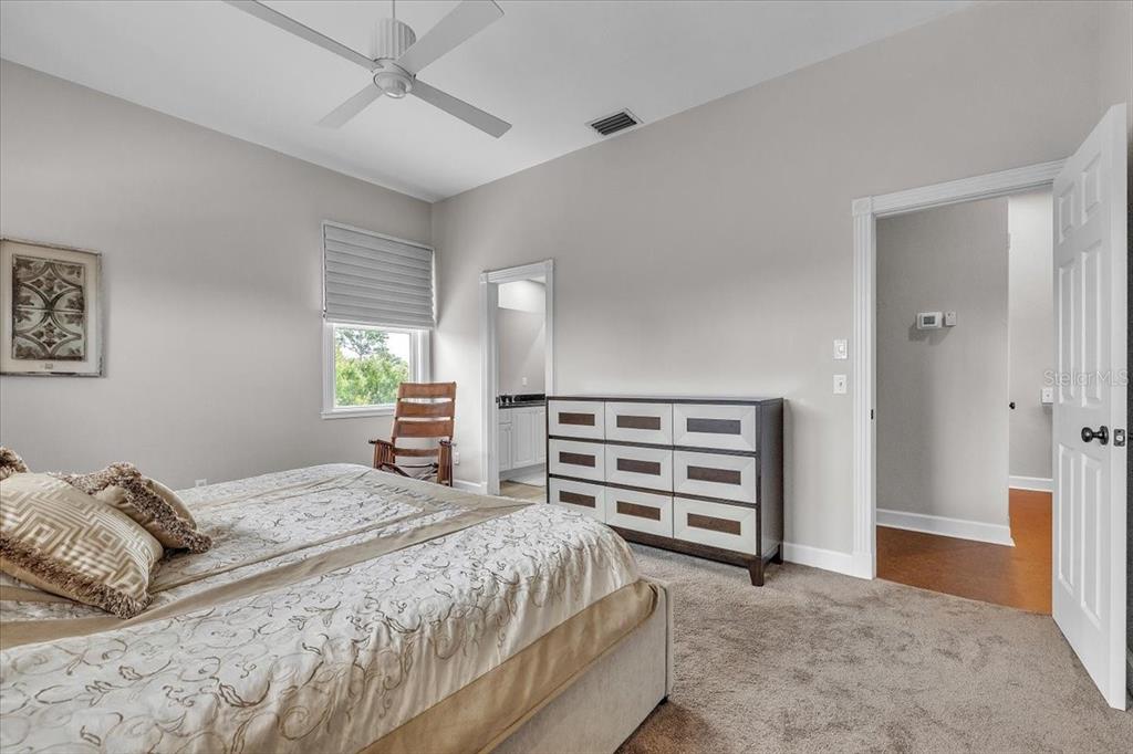 3850 Acline Road Punta Gorda, FL 33950 - Photo 31 of 50 a bedroom with a bed and a chandelier