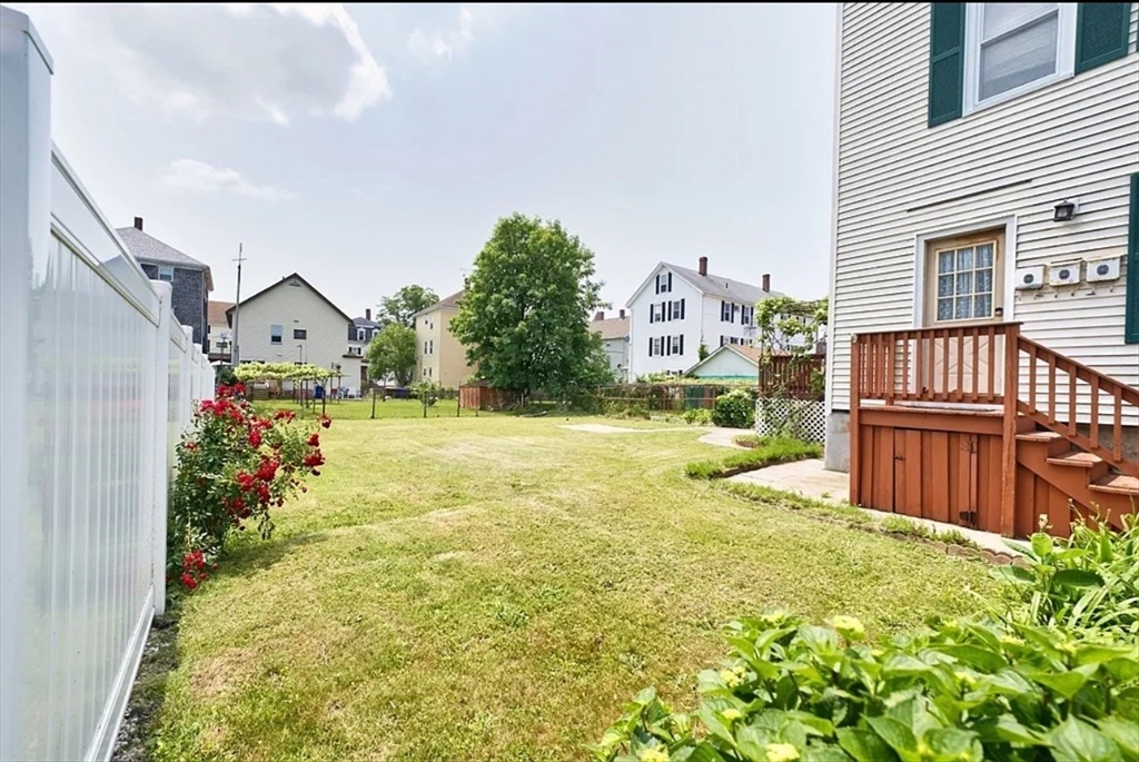 101 Cory Street, Unit 3 Fall River, MA 02720 - Photo 10 of 10 a view of a house with many windows next to a yard