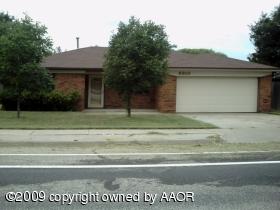 a view of a house with a wooden fence