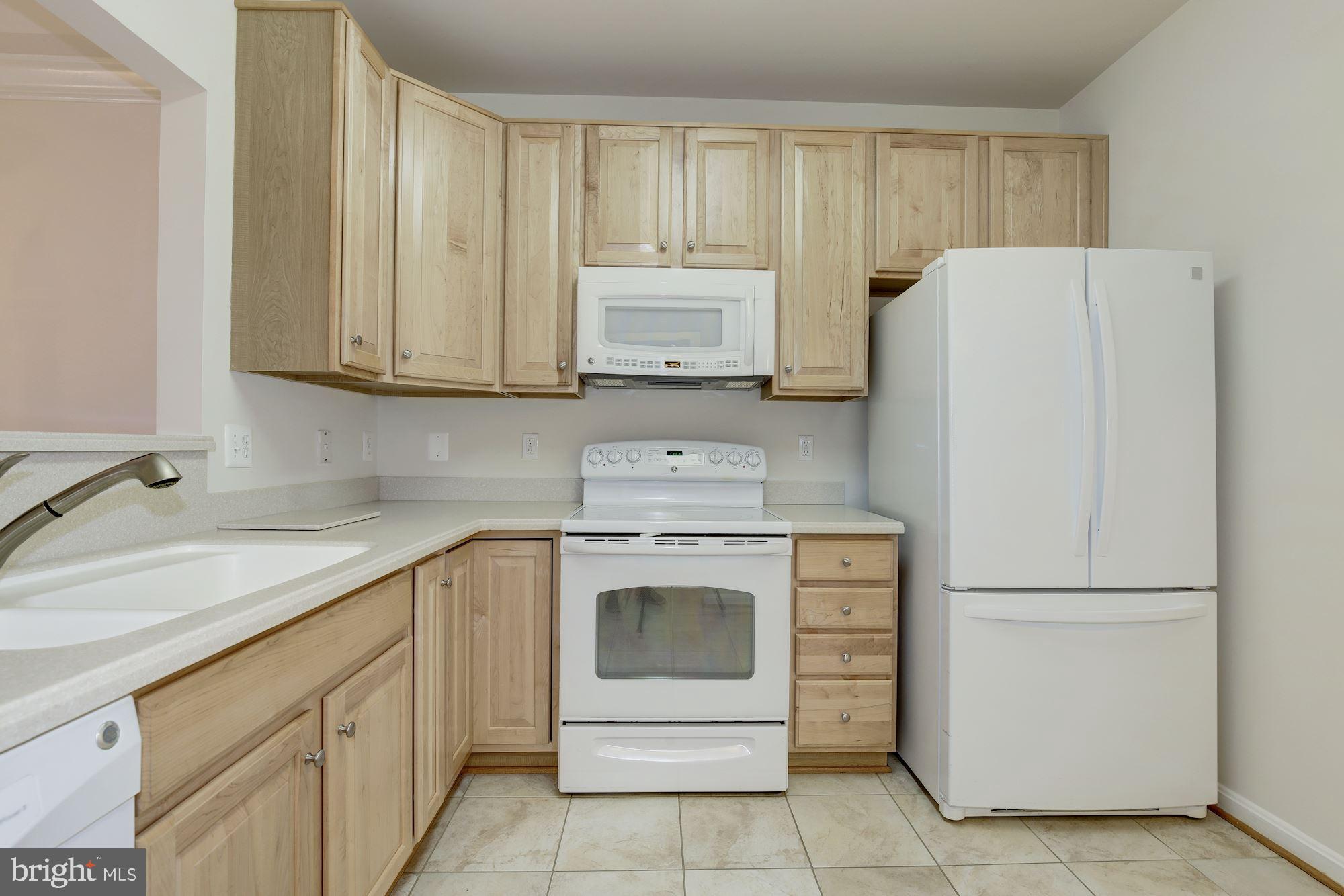 7305 Brookview Road, Unit 304 Elkridge, MD 21075 - Photo 7 of 45 Light Oak Cabinets & Corian Counters