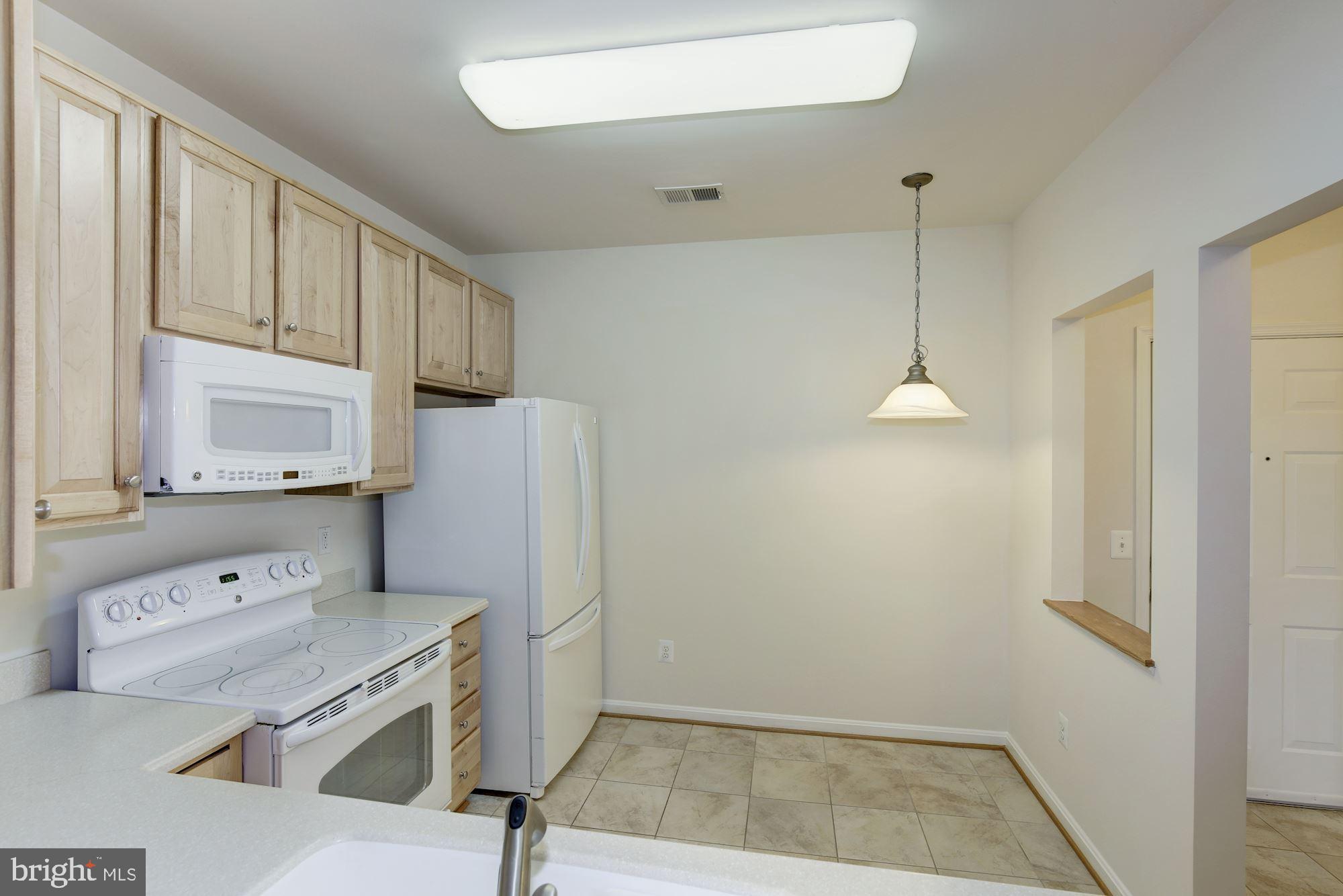 7305 Brookview Road, Unit 304 Elkridge, MD 21075 - Photo 9 of 45 Kitchen-Table Space & Pass-through to Dining Room