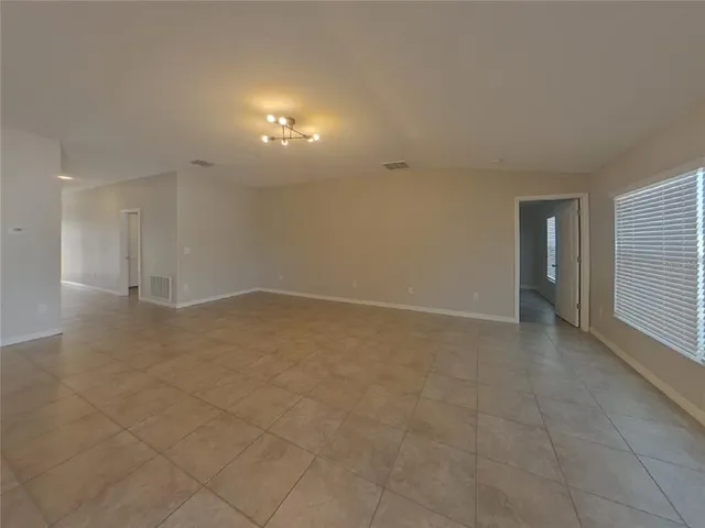 a kitchen with a sink cabinets and wooden floor