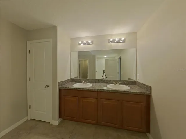 a view of an empty room and window and wooden floor