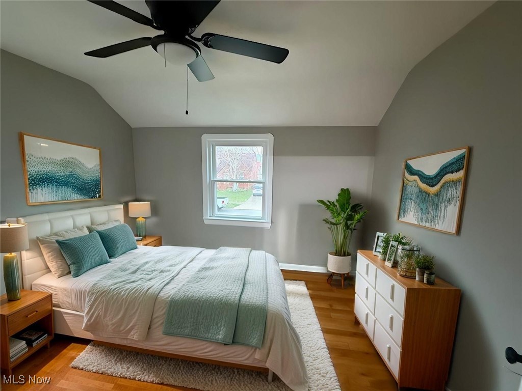 6807 Gerald Avenue Parma, OH 44129 - Photo 16 of 25 Bedroom featuring vaulted ceiling, a ceiling fan, baseboards, and light wood finished floors virtually staged
