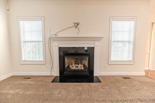 a living room with a fireplace and a window