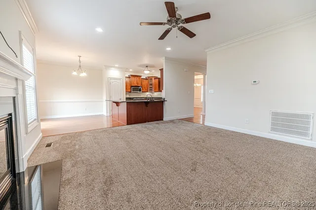 a open kitchen with stainless steel appliances a refrigerator and a sink
