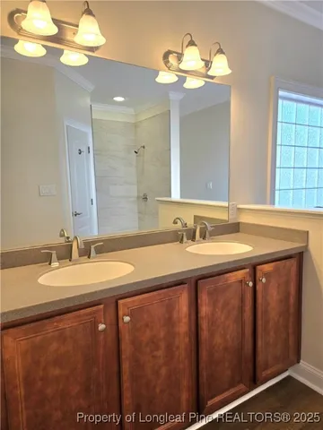a bathroom with a granite countertop sink a large mirror and a shower