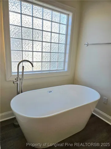 a white bath tub sitting next to a window