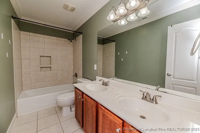 a bathroom with a bathtub shower sink vanity and toilet