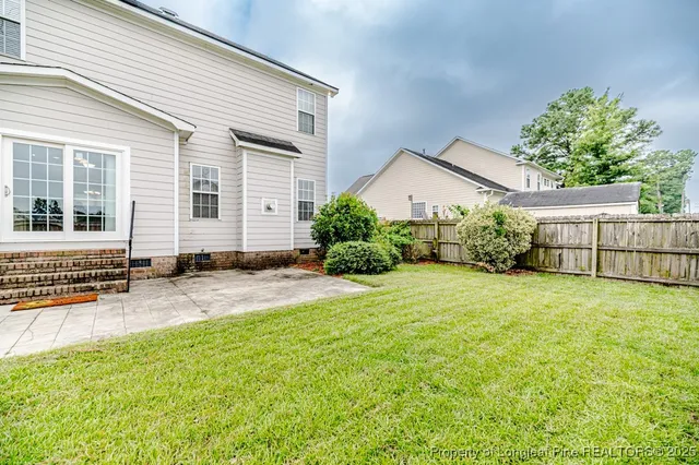 a view of a house with a yard and pathway