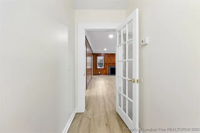 a view of hallway with wooden floor