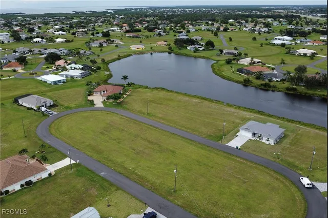 an aerial view of a pool yard lake and residential houses with outdoor space