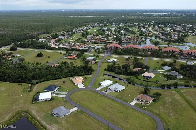 an aerial view of a pool a yard basket ball court