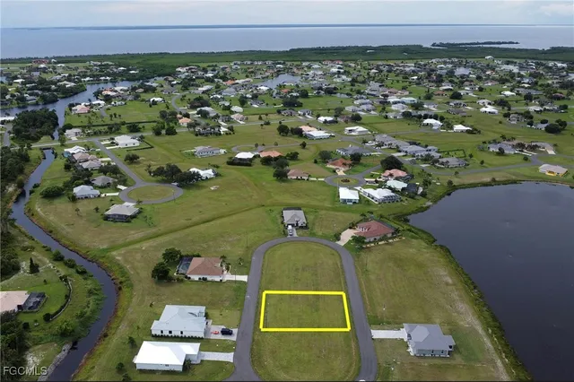 an aerial view of a house with a yard basket ball court and outdoor seating
