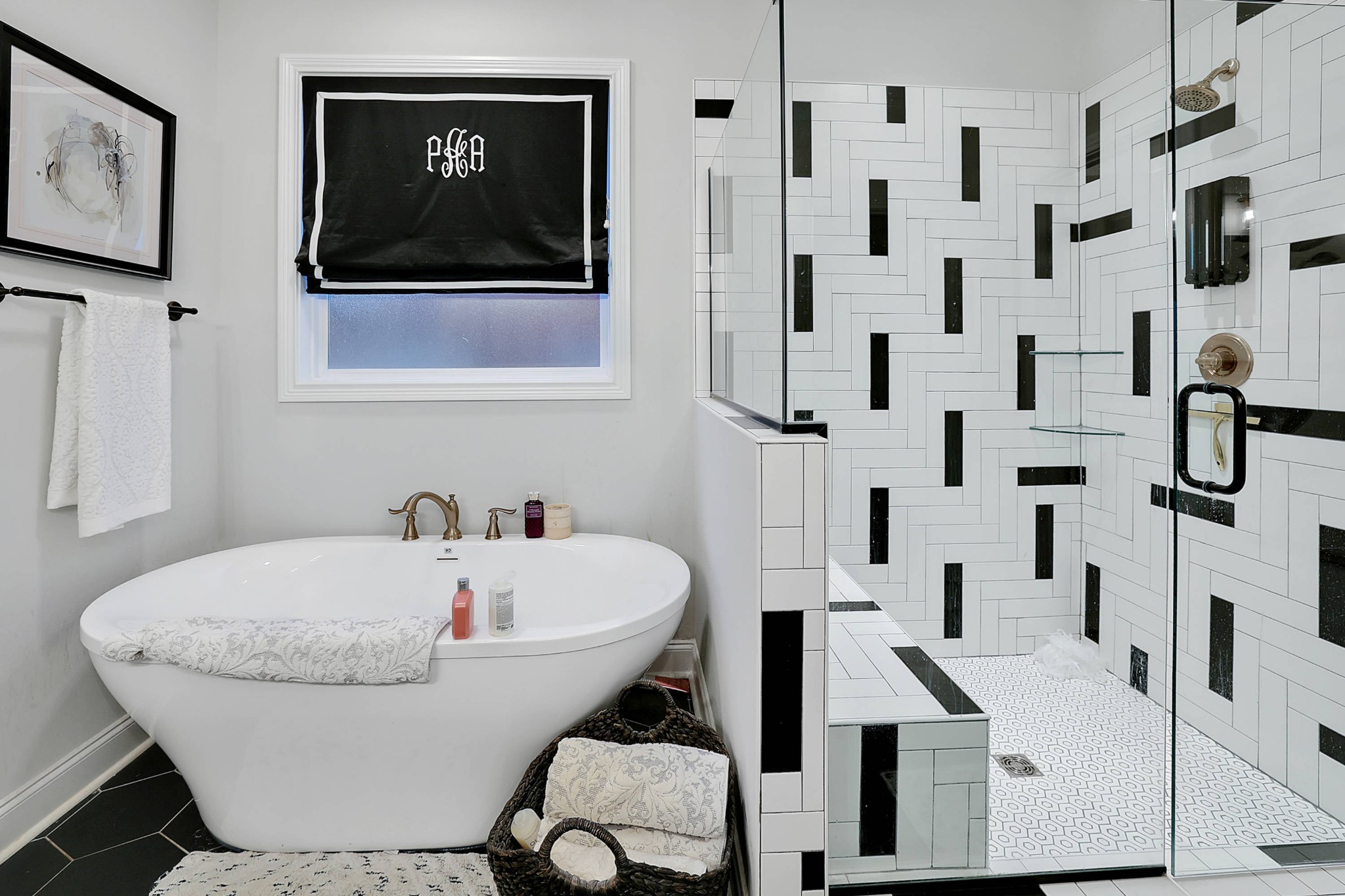 a white bath tub sitting next to a white sink and vanity