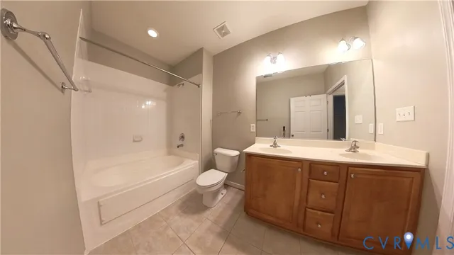 a utility room with wooden floor washer and dryer