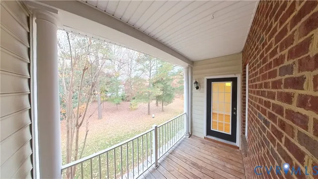 a view of an empty room with a window and a ceiling fan