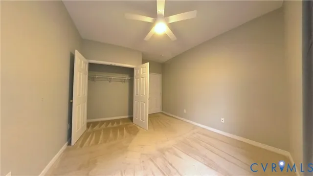 a view of a kitchen with fridge and wooden floor
