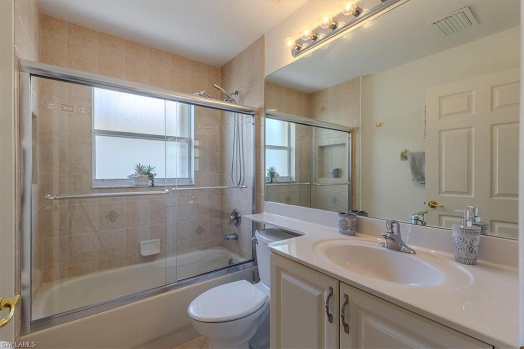 1630 Triangle Palm Terrace Naples, FL 34119 - Photo 16 of 24 a bathroom with a sink a toilet and shower