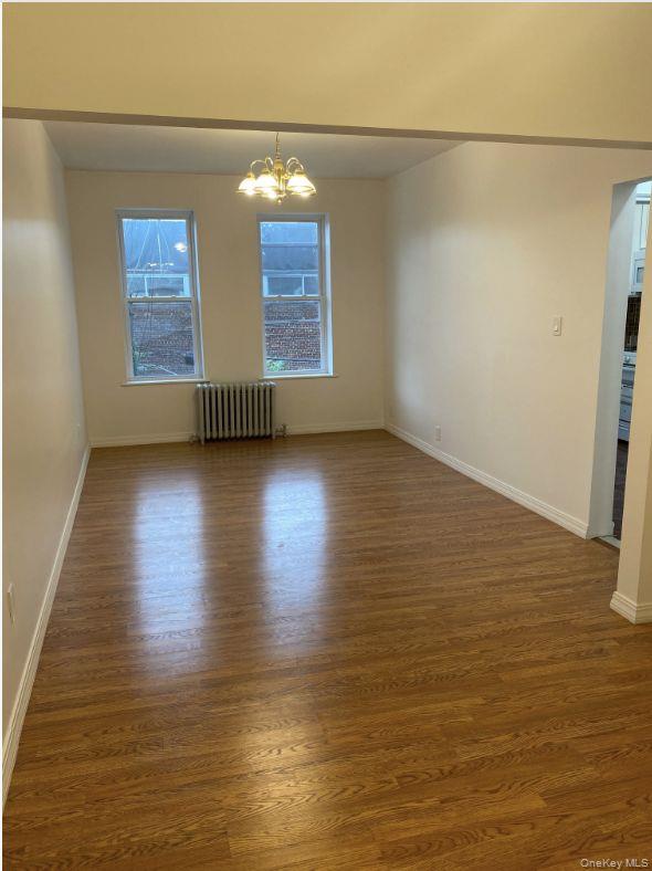 1270 42nd Street, Unit 2 Brooklyn, NY 11219 - Photo 2 of 7 a view of empty room with window and wooden floor
