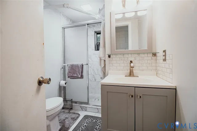 a bathroom with a sink toilet and mirror
