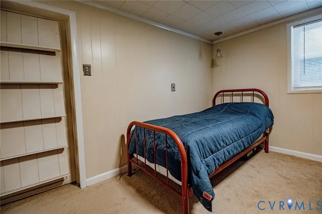 a bedroom with a bed and cabinet