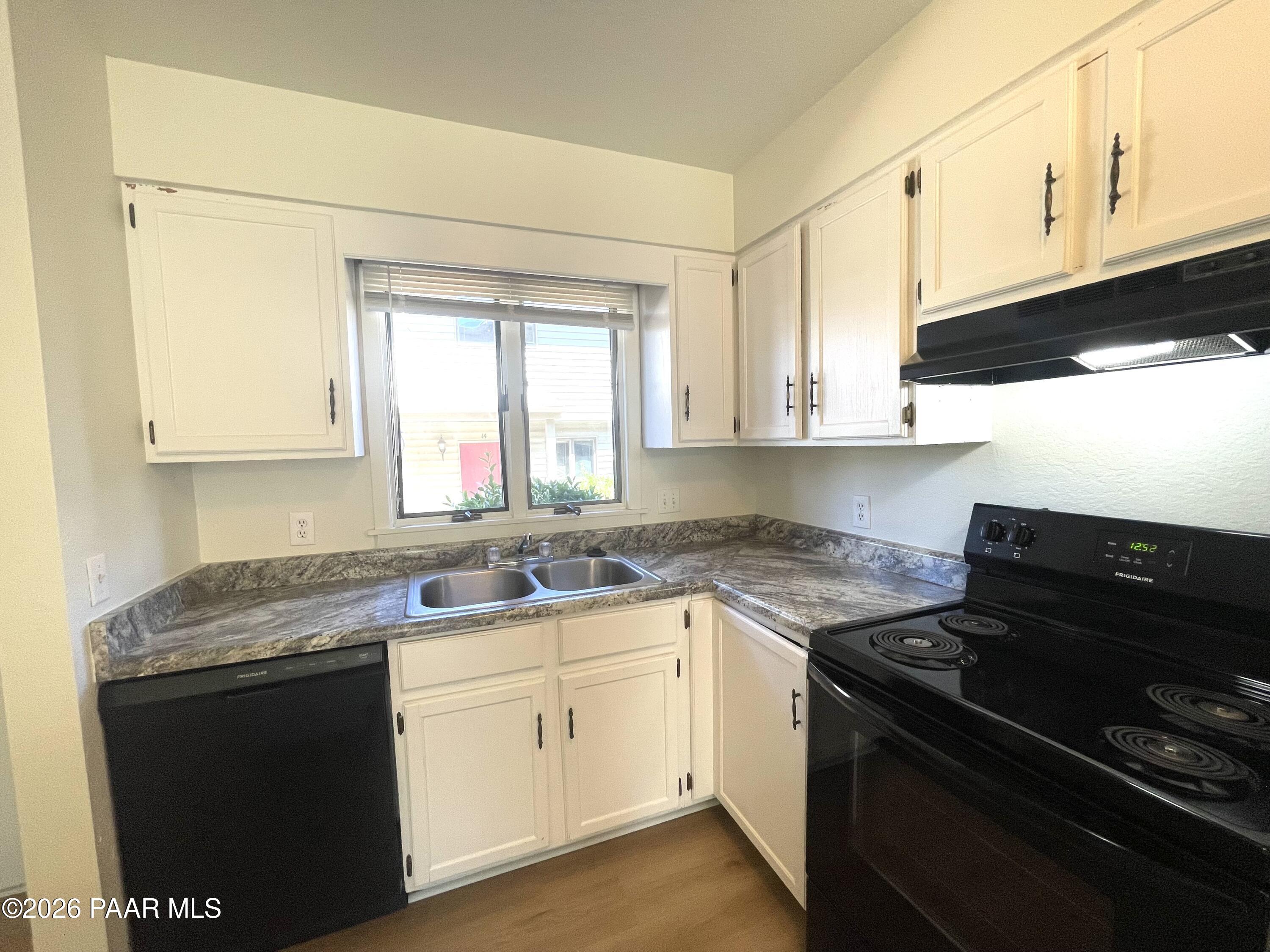 1230 Stetson Road, Unit 10 Prescott, AZ 86303 - Photo 5 of 11 a kitchen with a sink stove and cabinets
