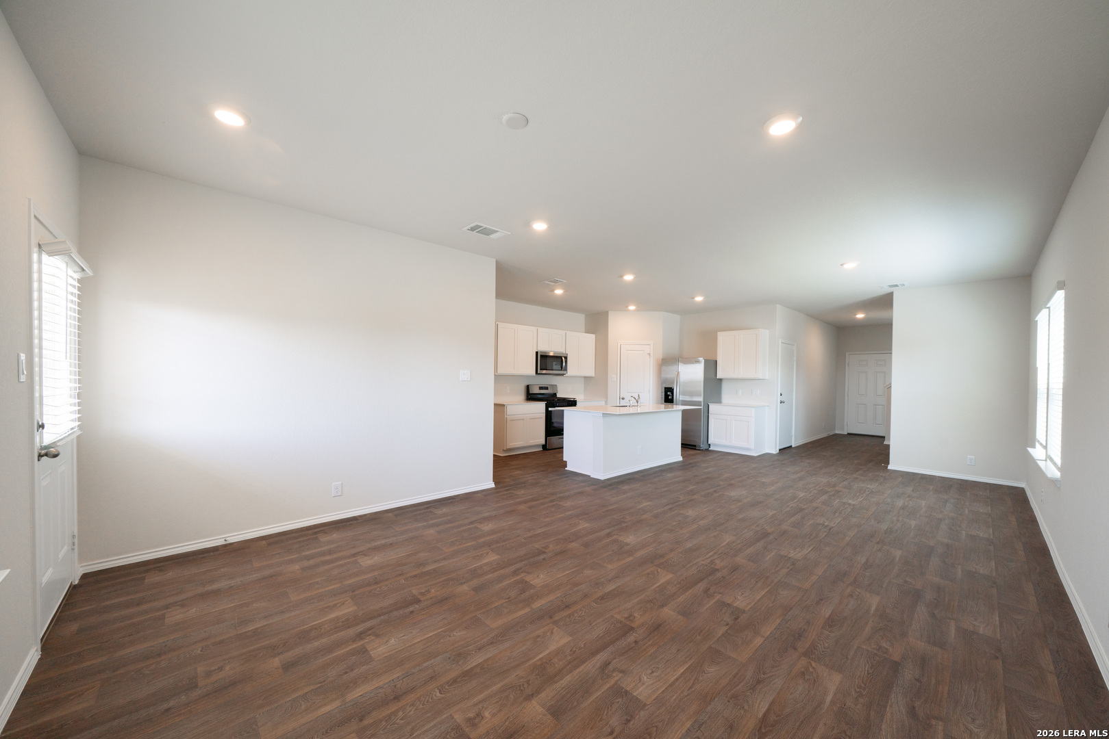 14674 Clay Rdg Run San Antonio, TX 78253 - Photo 12 of 14 a view of a kitchen with a sink and dishwasher a refrigerator with wooden floor